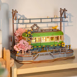 Rolife Sakura Journey tram model illuminated with warm LED light on display