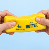 Yellow salted butter sensory squishy toy being squeezed