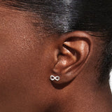 Silver infinity earrings worn on ear