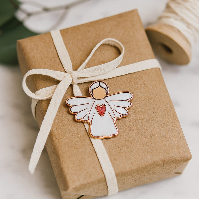 Splosh Angel of Strength pin presented on a gift box with ribbon, perfect for sympathy or encouragement gifts.