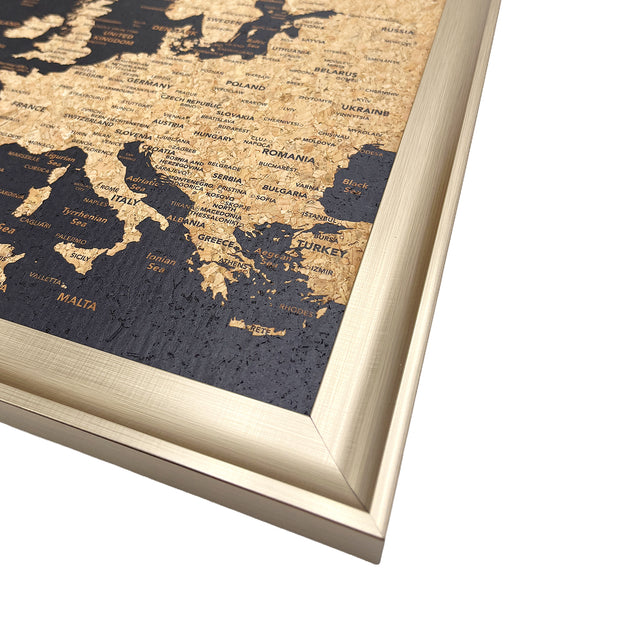 Close-up of European destinations and cork detail on the Splosh black map with gold frame