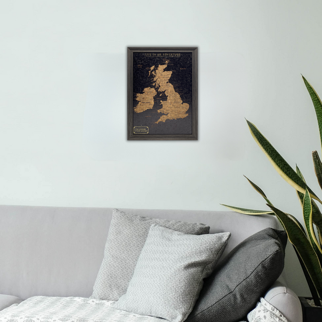 Splosh Black UK and Ireland map with pins displayed on a bedroom wall