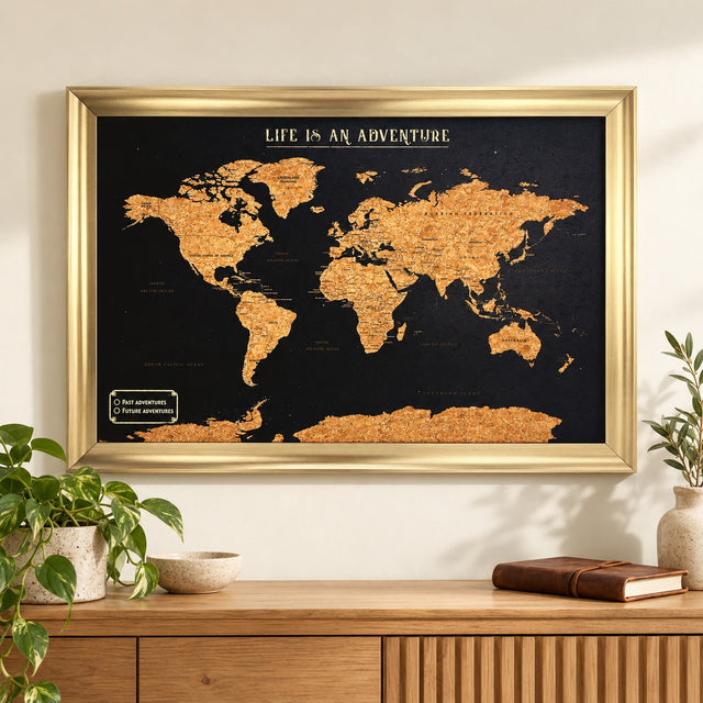 Splosh black World travel map with gold frame on a wall above an oak sideboard