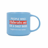 Splosh Cheeky Mug Tolerate – blue ceramic mug with red and white text reading “People who tolerate me on a daily basis. They’re the real heroes.” Funny witty coffee mug gift.