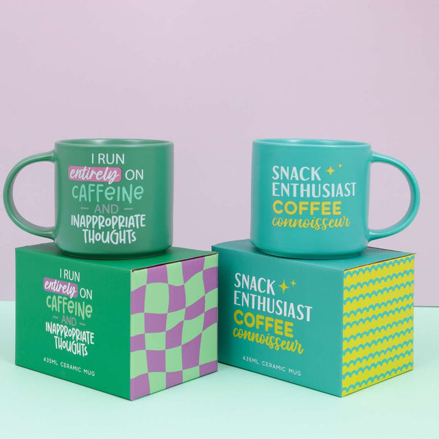 Splosh Cheeky Mugs displayed with bright gift boxes, featuring the green caffeine mug with cheeky quote – perfect novelty gift for coffee lovers.