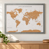 Splosh grey World travel map with grey woodgrain frame, wall display above an oak sideboard