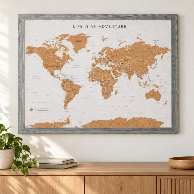 Splosh grey World travel map with grey woodgrain frame, wall display above an oak sideboard