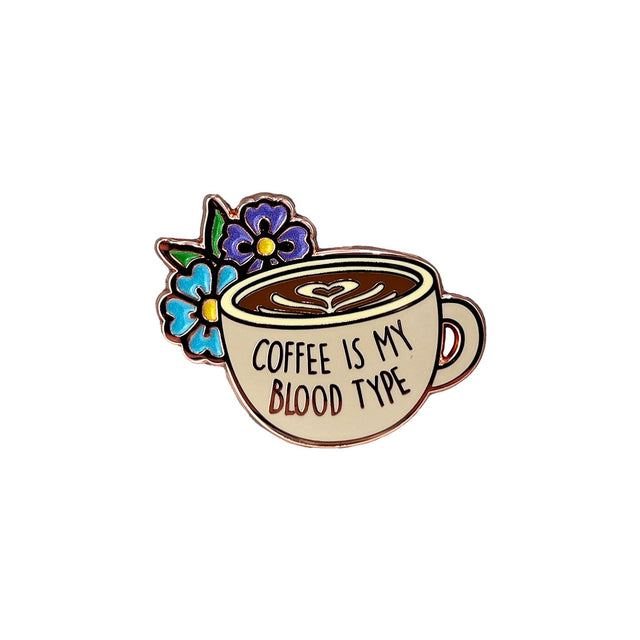 Close-up of Splosh Coffee Lover enamel pin shaped like a coffee cup
