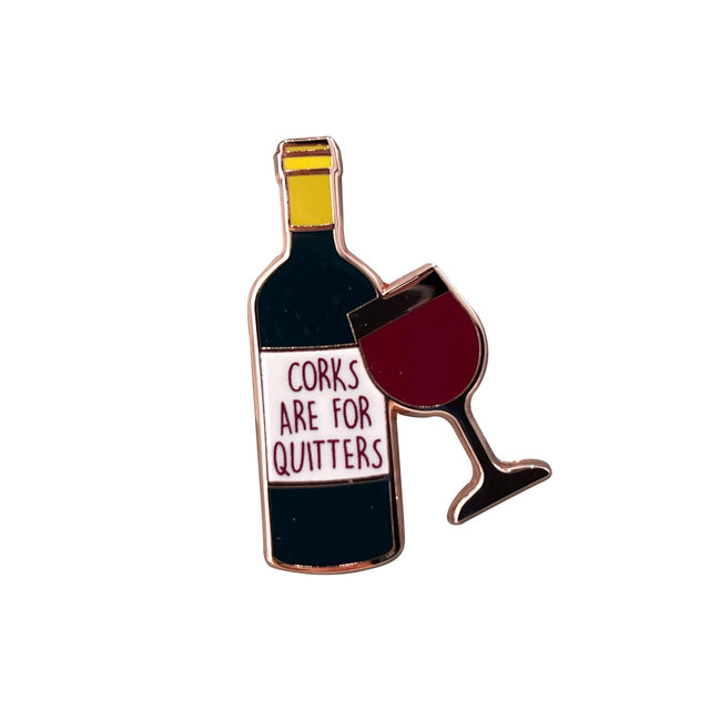 Close-up of Splosh Wine Lover enamel pin showing wine bottle and glass design
