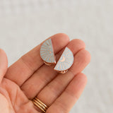 Close-up of Soul Sisters enamel pin halves held in hand