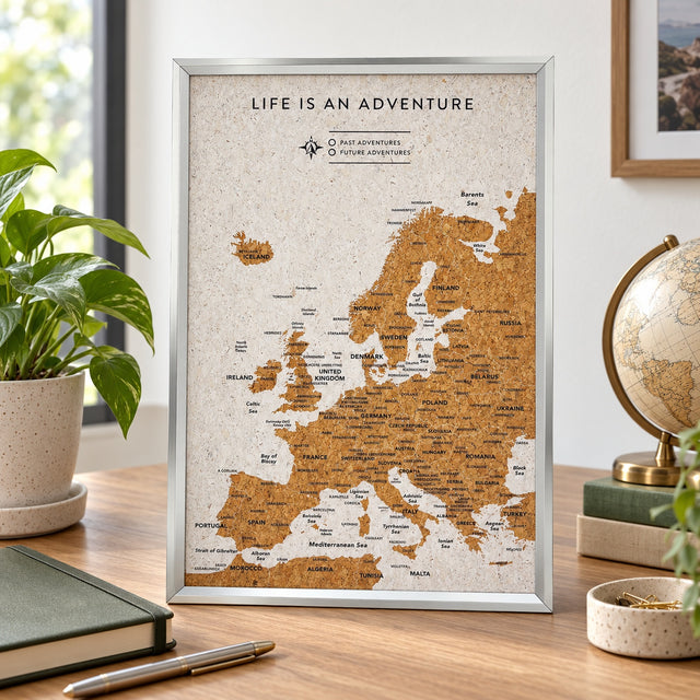Splosh white Europe travel map with silver frame displayed on wooden furniture in a neutral home setting