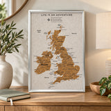 Splosh white UK & Ireland travel map with silver frame displayed on wooden furniture in a neutral home setting