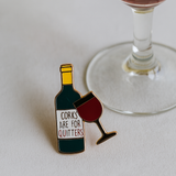 Splosh Wine Lover enamel pin styled next to a wine glass