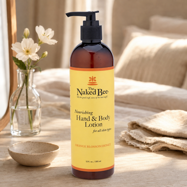 The Naked Bee body moisturiser displayed on a softly lit dressing table