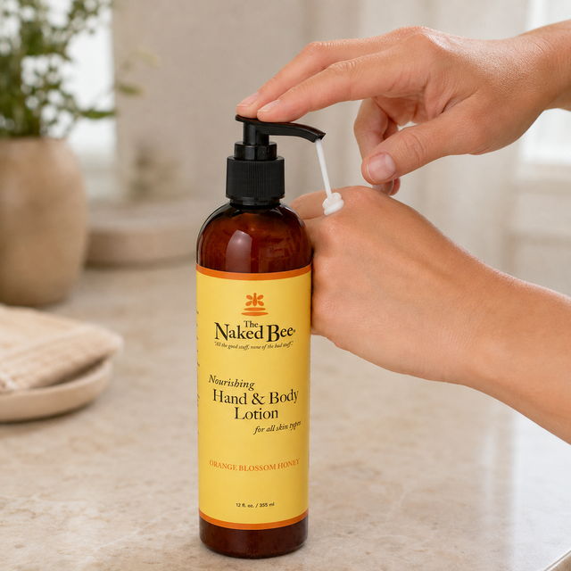 The Naked Bee hand and body lotion being dispensed onto the back of a hand