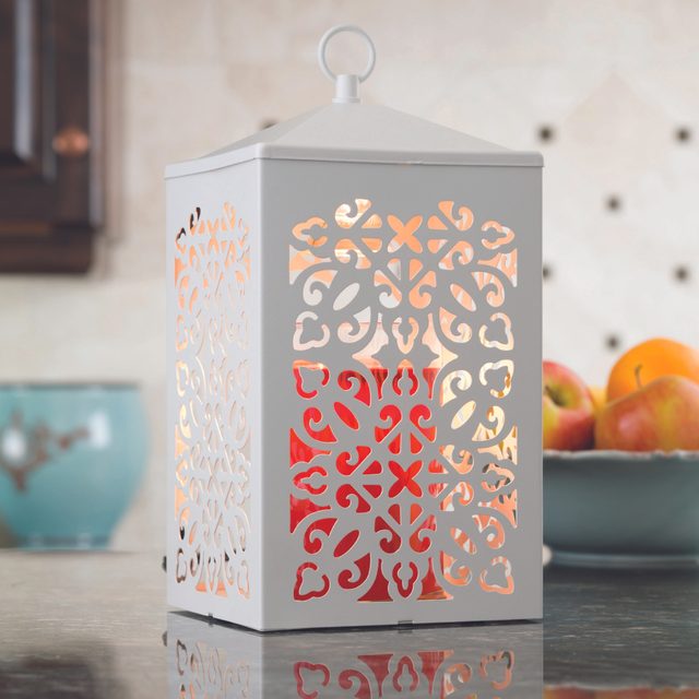 White candle warmer lamp holding a scented jar candle