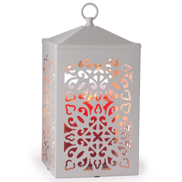 Decorative metal scrollwork on white candle warmer lamp