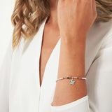 This ones for the October girls, whether youre treating yourself or someone you love! Our lovely October A Little Birthstone Bracelet radiates beauty with real semi-precious Tourmaline gemstones and a gently hammered silver star charm. Thanks to our signature stretch bead design, this silver-plated treasure provides a perfect fit now and forever.
