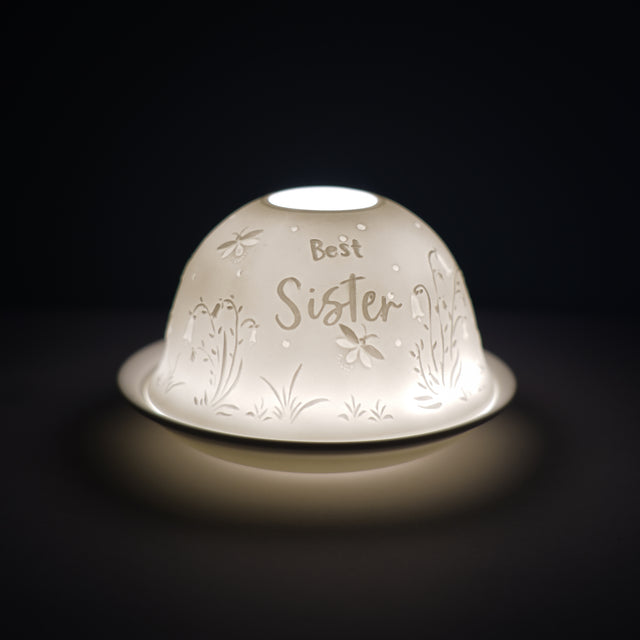 Cello porcelain tealight holder dome, in our best sister design. This design displays the text best sister over a gentle display of flowers. We offer a wide range of porcelain tealight holders to let you choose your show stopping piece and show it off with pride when guests and family are over.  Pick your preferred option between LED lights or using tealight candles.