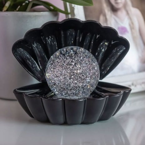 Soothing for those who struggle to settle at nighttime, the swirling glitter and gentle changes between each hue reflecting against the black shell help to calm and relax us as we wind down for bed.